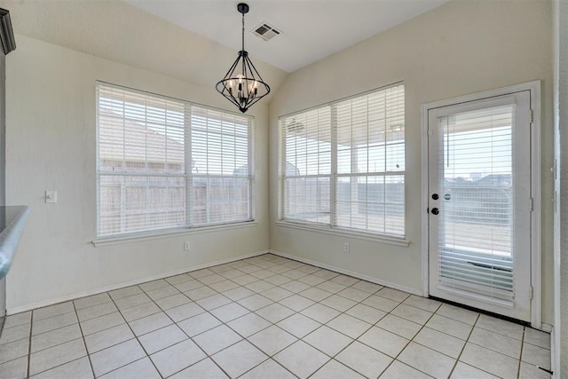 unfurnished dining area featuring light tile patterned floors, vaulted ceiling, and a notable chandelier