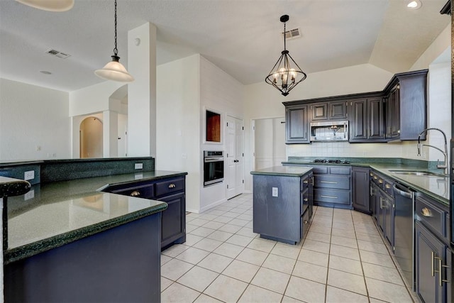 kitchen featuring sink, a center island, decorative light fixtures, and appliances with stainless steel finishes