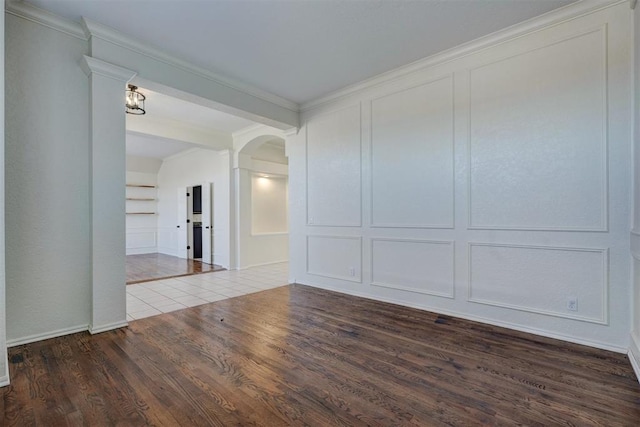 unfurnished room with crown molding, built in features, and dark hardwood / wood-style floors