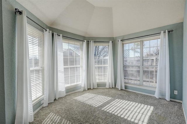 unfurnished sunroom featuring vaulted ceiling