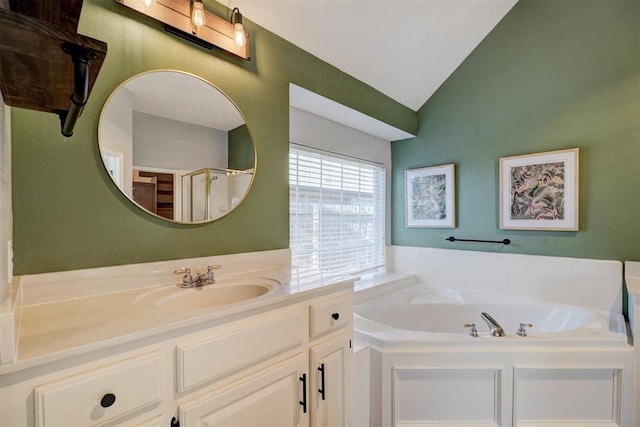 bathroom with vanity, independent shower and bath, and vaulted ceiling