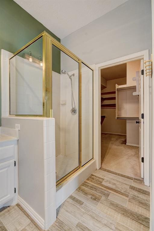 bathroom featuring vanity, hardwood / wood-style flooring, and an enclosed shower