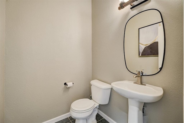 bathroom with tile patterned flooring and toilet