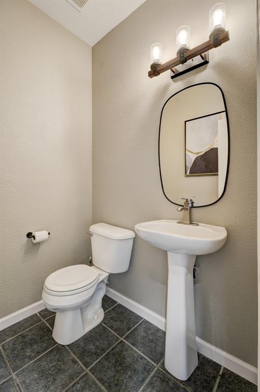 bathroom featuring tile patterned floors and toilet