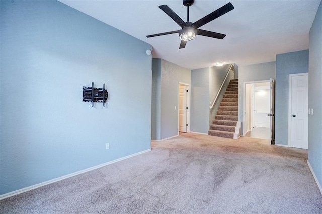 empty room with light colored carpet and ceiling fan