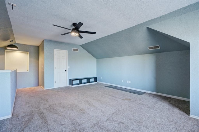 additional living space featuring carpet flooring, a textured ceiling, ceiling fan, and lofted ceiling