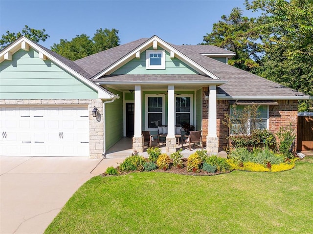 craftsman-style home with a porch, a garage, and a front lawn