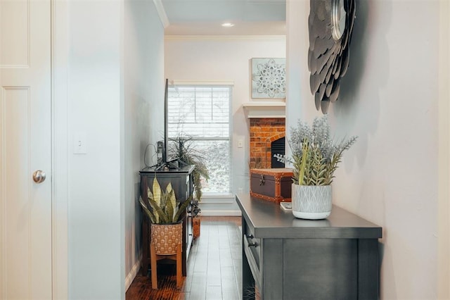 corridor with dark hardwood / wood-style flooring and crown molding