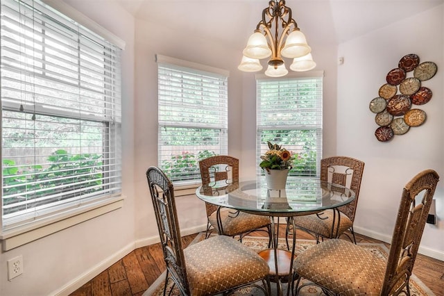 dining space with a chandelier and hardwood / wood-style flooring