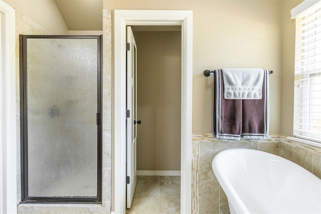 bathroom with tile patterned floors and independent shower and bath