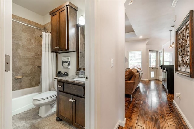 full bathroom featuring shower / bath combination with curtain, vanity, hardwood / wood-style flooring, and toilet