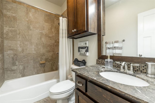 full bathroom featuring vanity, shower / bath combination with curtain, and toilet