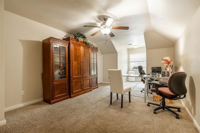 carpeted office space with ceiling fan and vaulted ceiling