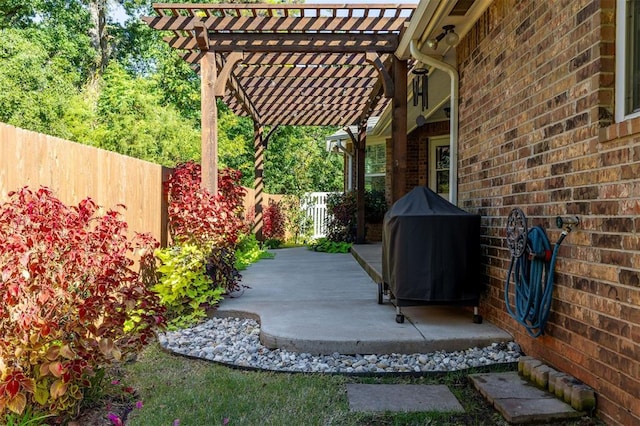 view of patio featuring a pergola and a grill