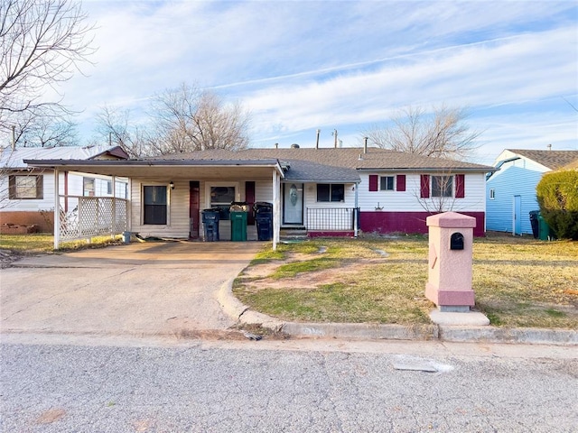 ranch-style home featuring a carport, a porch, a front yard, and driveway