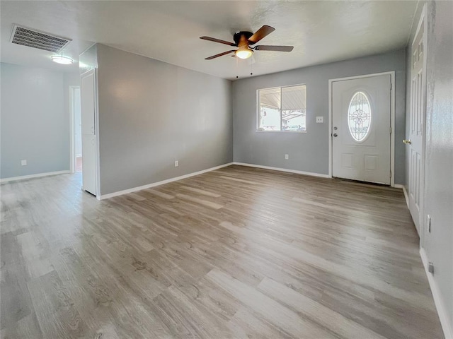 entryway with light wood-type flooring, visible vents, and baseboards