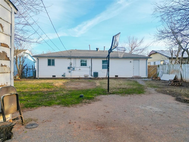 rear view of house with crawl space, fence, central AC, and a yard