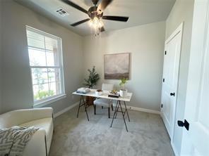 office space featuring light carpet and ceiling fan