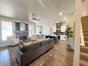 living room featuring ceiling fan and hardwood / wood-style floors