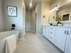 bathroom with vanity and a tub to relax in