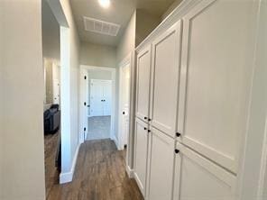 corridor with dark hardwood / wood-style floors