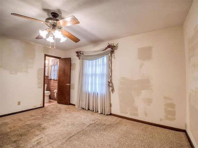 carpeted empty room featuring ceiling fan