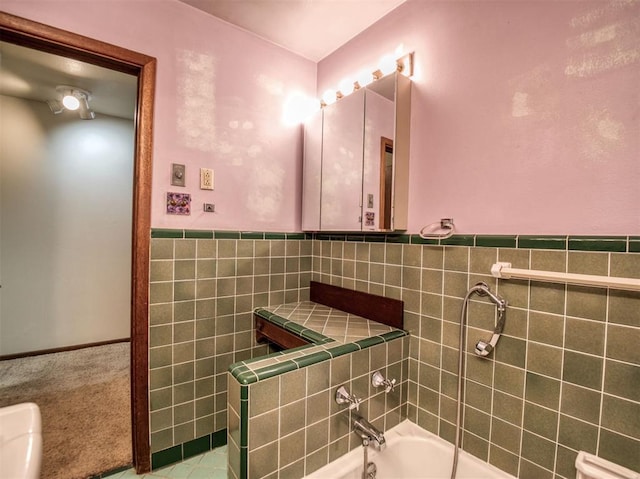 bathroom featuring a washtub and tile walls