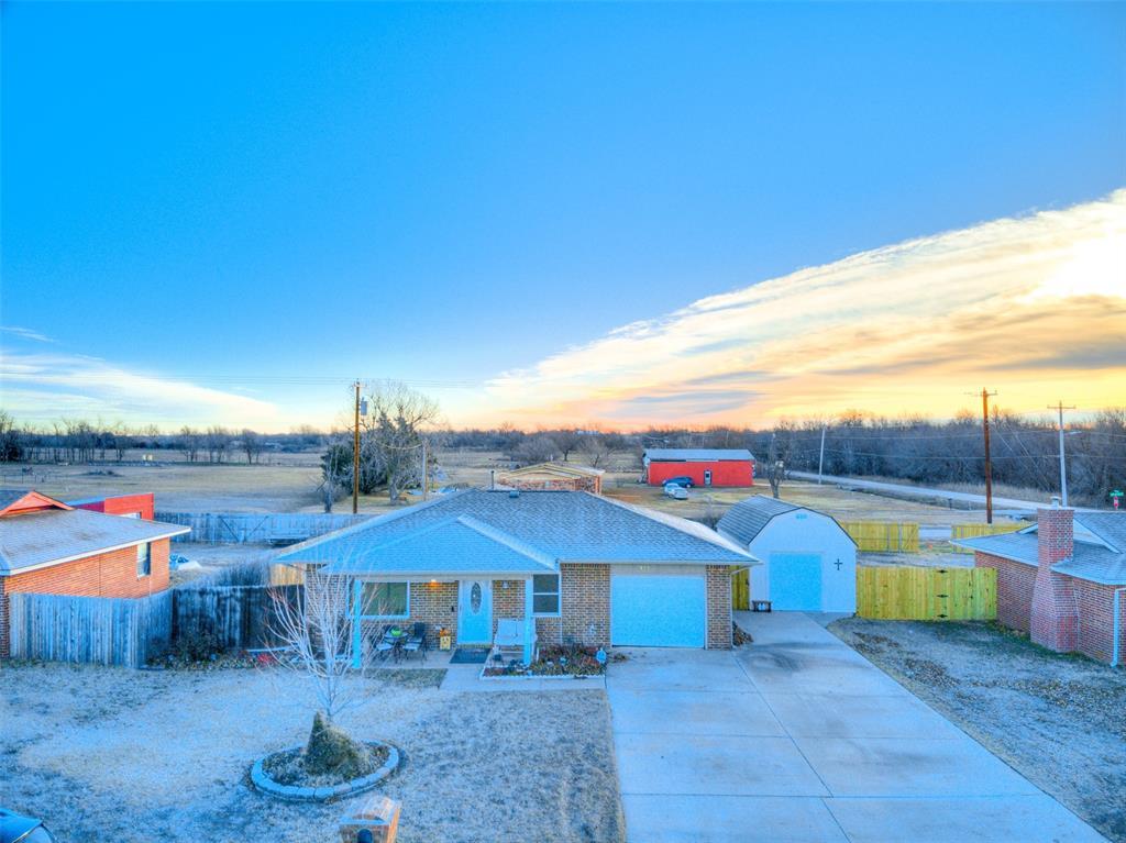 ranch-style house featuring a garage and covered porch