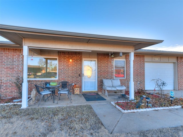 property entrance featuring a patio and a garage