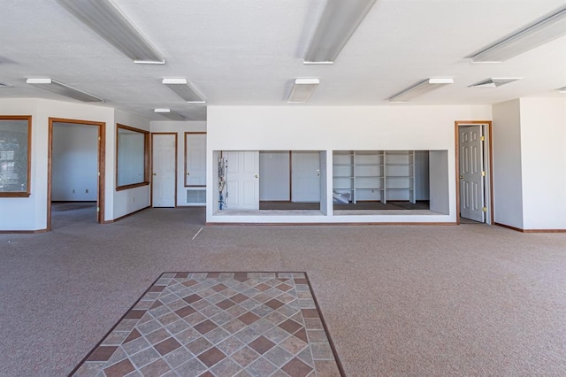 interior space featuring dark colored carpet