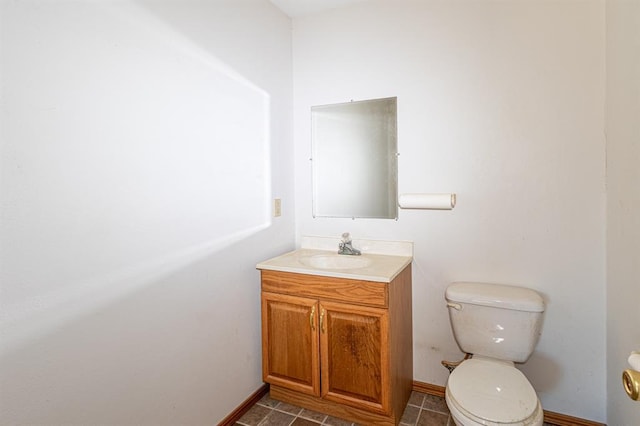 bathroom with tile patterned floors, vanity, and toilet