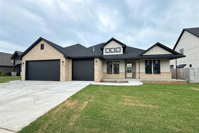 9224 NW 83rd St, Yukon, OK 73099 - view of front of home featuring brick siding, a garage, driveway, covered porch, and roof with shingles