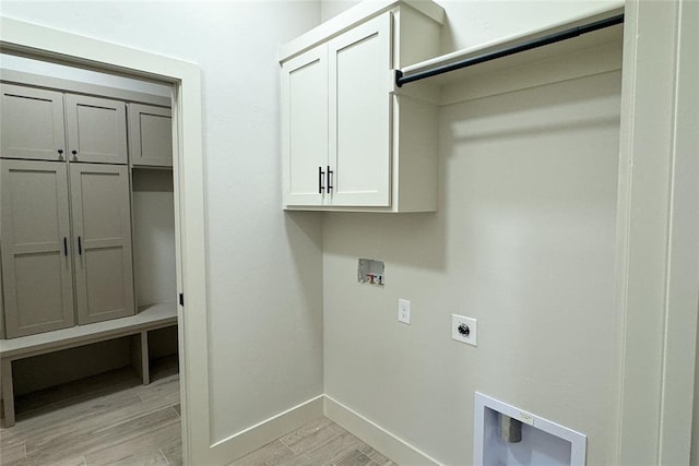 9224 NW 83rd St, Yukon, OK 73099 - laundry room with hookup for an electric dryer, cabinet space, light wood-style floors, baseboards, and washer hookup