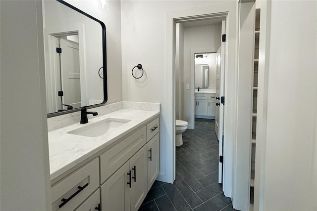 9224 NW 83rd St, Yukon, OK 73099 - bathroom featuring toilet, vanity, and tile patterned floors
