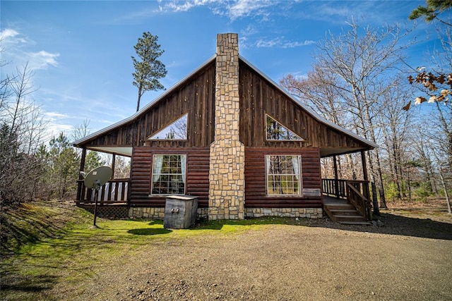 view of side of property featuring covered porch