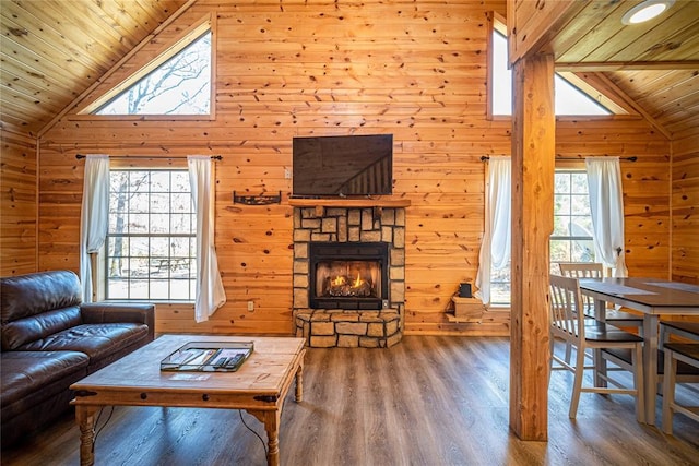 living room featuring wood walls, a fireplace, wood ceiling, and hardwood / wood-style flooring