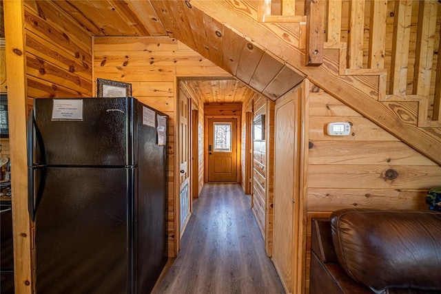 corridor featuring wood walls, dark wood-type flooring, wood ceiling, and lofted ceiling