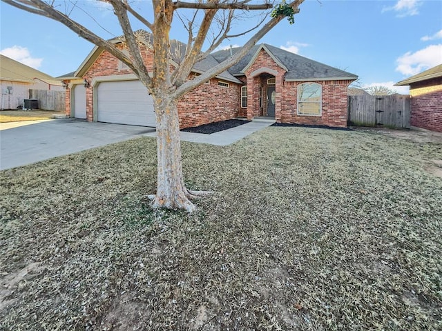 single story home featuring central AC unit, a garage, and a front lawn