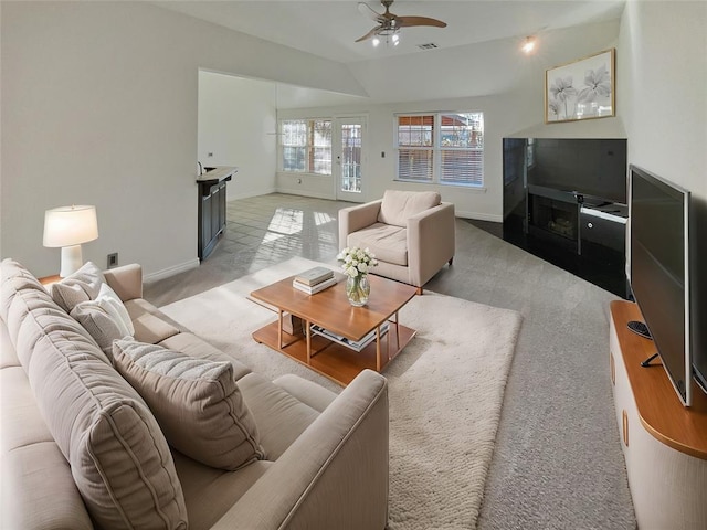 living room featuring ceiling fan, lofted ceiling, and light carpet