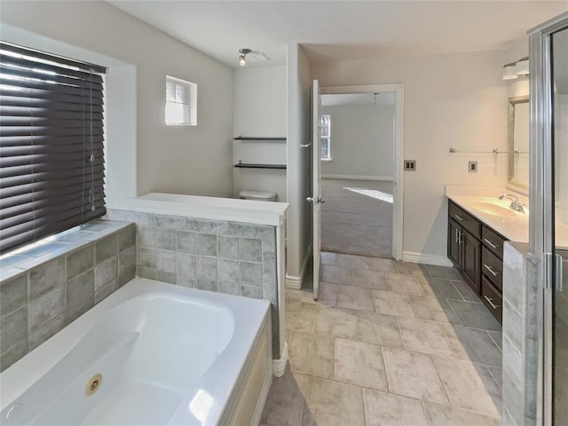 bathroom with a washtub and vanity