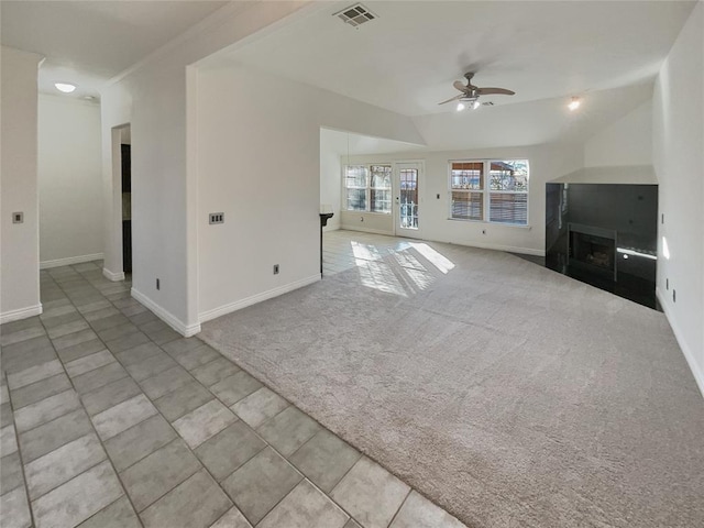 unfurnished living room with ceiling fan, light carpet, and vaulted ceiling