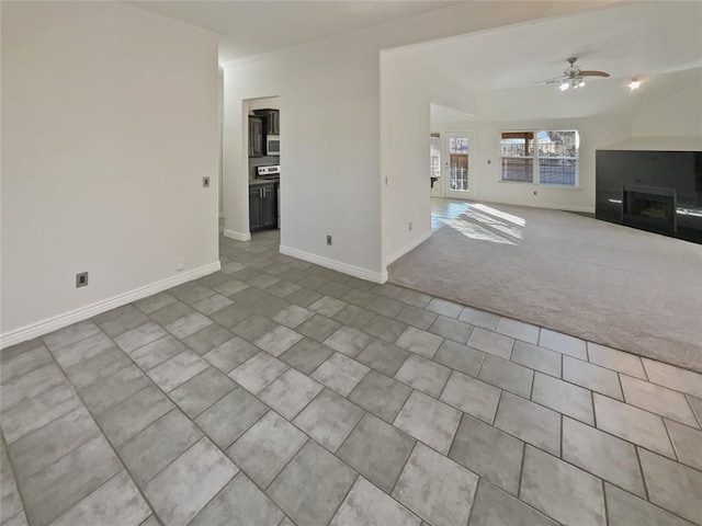 unfurnished living room with ceiling fan and light colored carpet