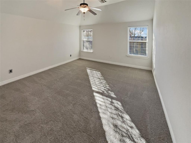 carpeted empty room with ceiling fan and plenty of natural light