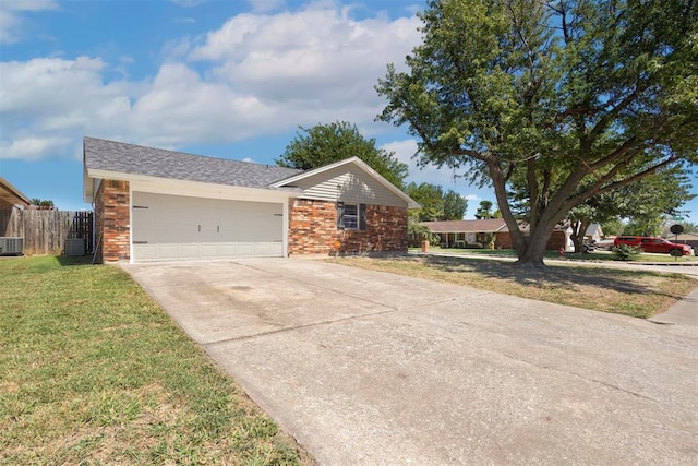 ranch-style house with a garage, a front lawn, and cooling unit