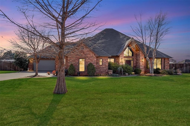 view of front of house featuring a yard and a garage