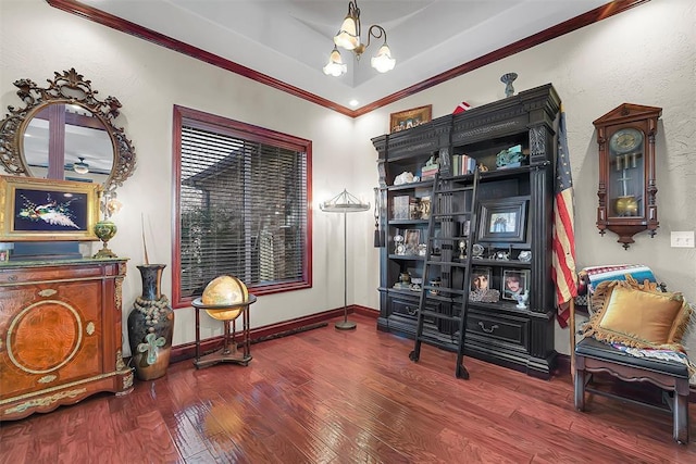 living area featuring a raised ceiling, crown molding, a chandelier, and dark hardwood / wood-style flooring