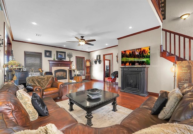 living room featuring crown molding, hardwood / wood-style floors, and ceiling fan