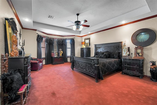 bedroom with ornamental molding, carpet flooring, a raised ceiling, and a textured ceiling