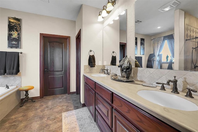 bathroom featuring tasteful backsplash, vanity, and shower with separate bathtub