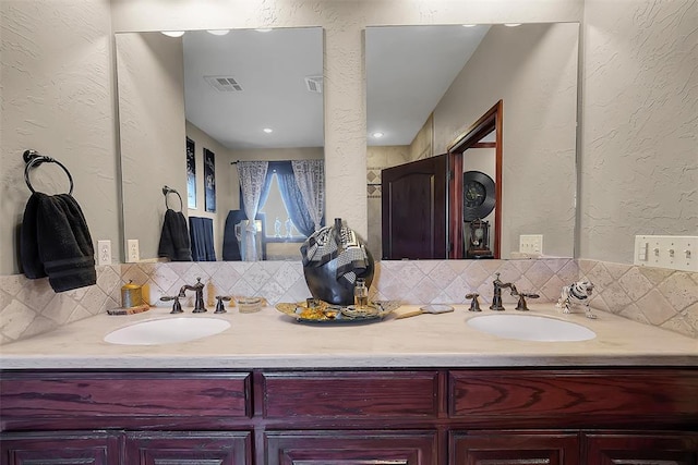 bathroom featuring vanity and decorative backsplash